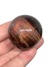 Load image into Gallery viewer, Chatoyant Red Tiger Eye Sphere